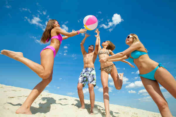 young people playing on a beach