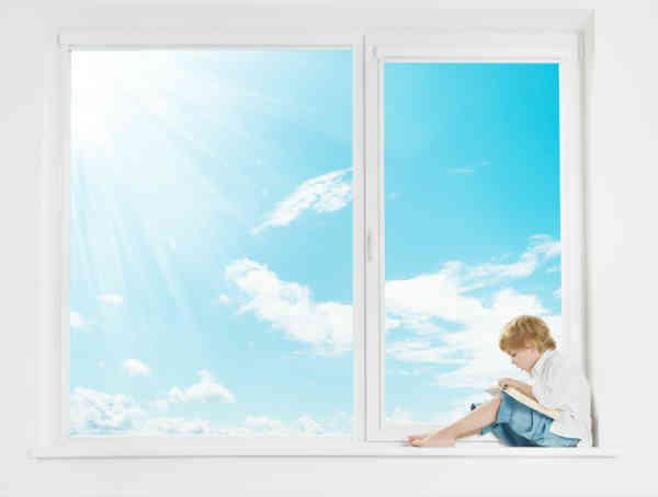 boy sitting in huge window