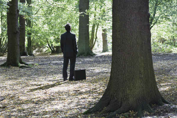 businessman alone in the woods