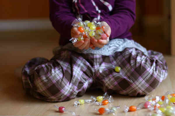 girl with big collection of bonbons