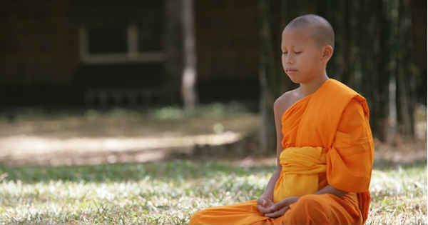 child monk meditating peacefully
