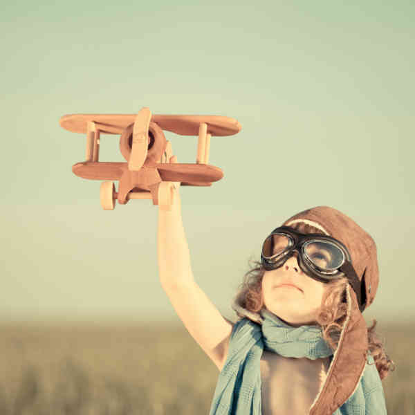 boy flying toy plane