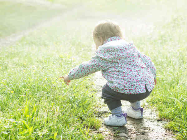child standing on grass