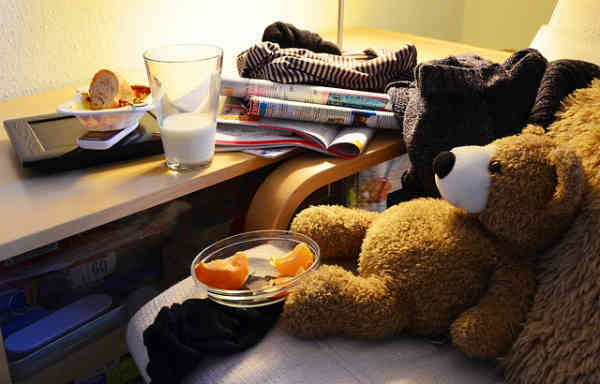 very messy room with teddy bear