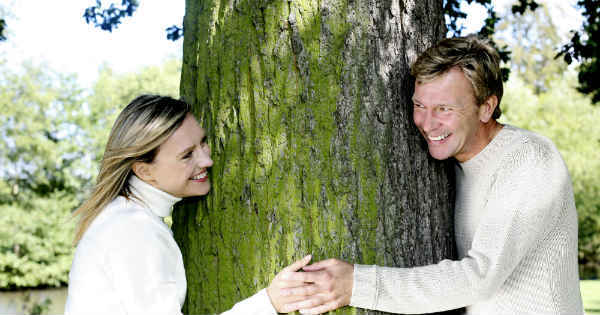 happy couple hugging a tree
