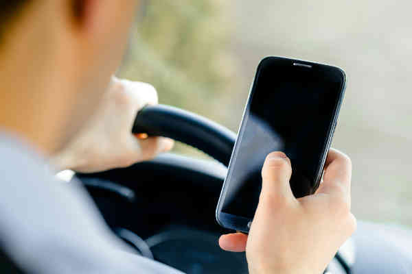 man distracted with mobile while driving