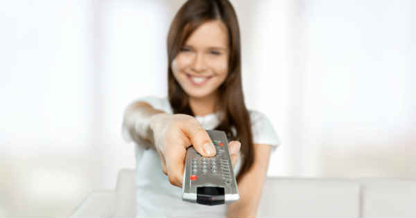 woman using tv remote