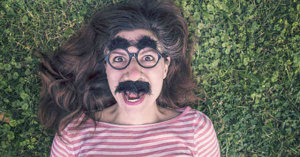 lady with mustache lying in grass