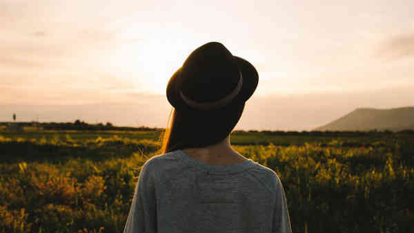 woman enjoying sunset in front of her