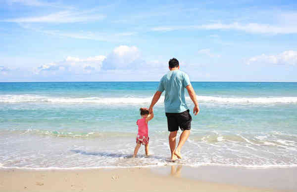 father and daughter on a beach
