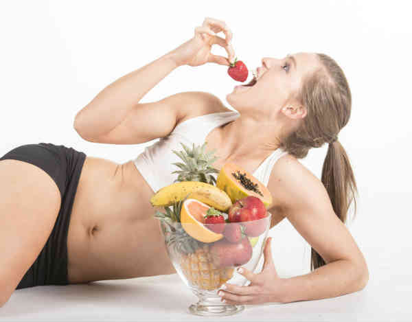 fit woman eating fruit