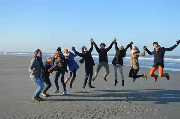 friends jumping on beach