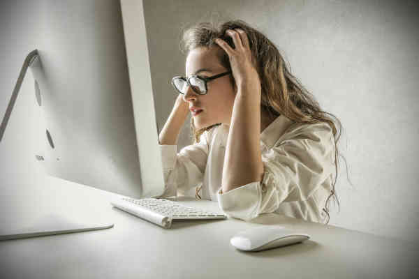 frustrated woman watching monitor screen