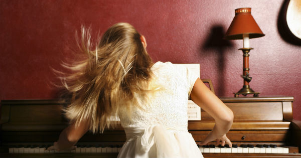 a girl playing a piano