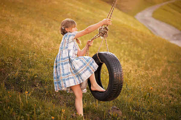 girl playing on makeshift swing