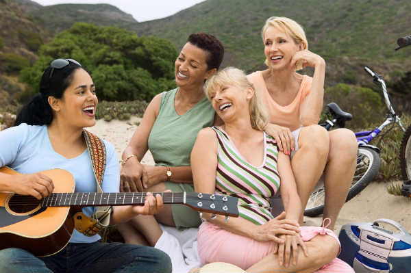 girlfriends making music together in nature