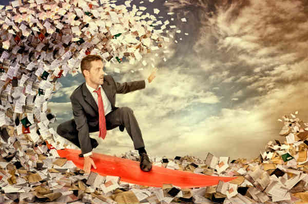 man surfing on waves of money