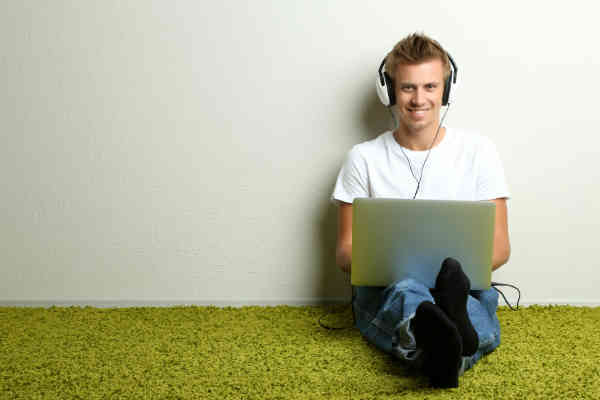 man writing on laptop