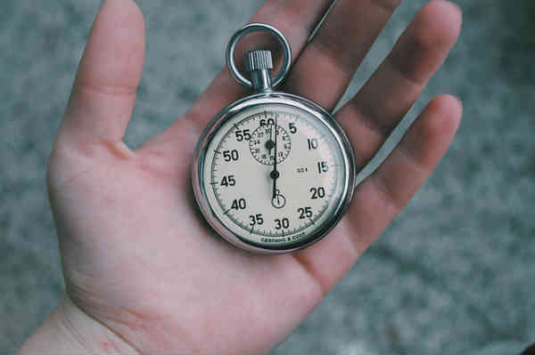 hand holding a pocket watch