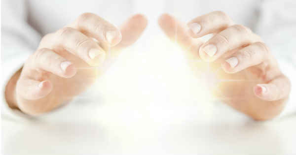 hands touching beaming light