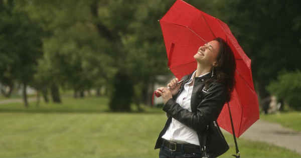 happy girl with umbrella as a barrier against rain
