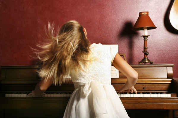 girl playing a piano