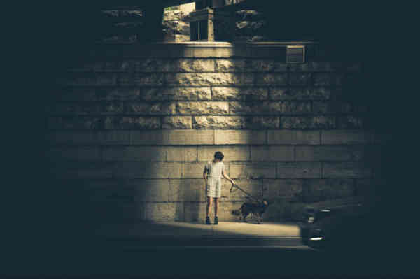 woman walking a dog at night