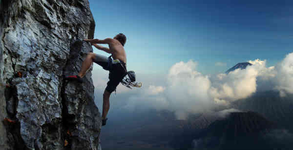 man climbing mountain