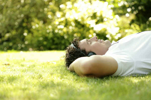 man enjoying sunlight and music