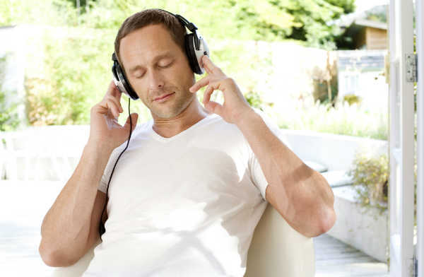 man listening to headphones in nature