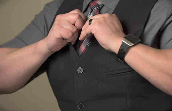 man adjusting his tie