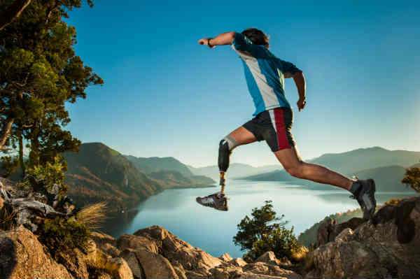 man jumping over cliff