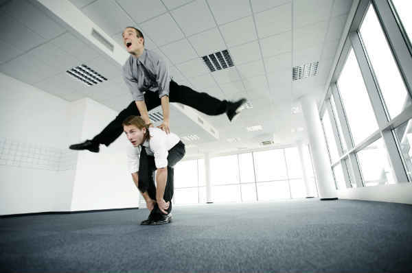 man jumping over his collegue