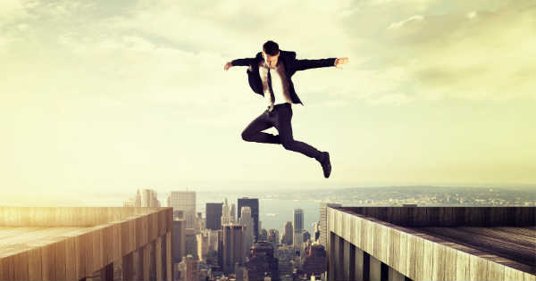 man jumping over buildings