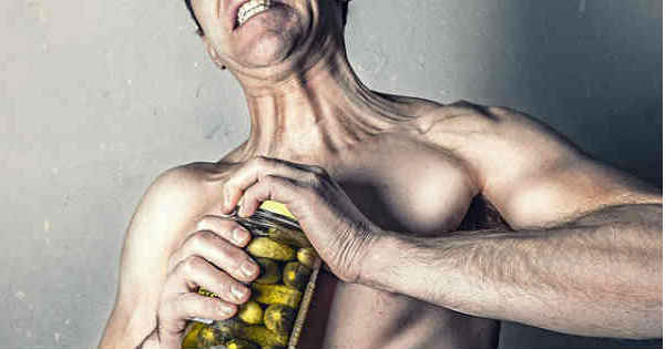 man furstrated with pickle jar