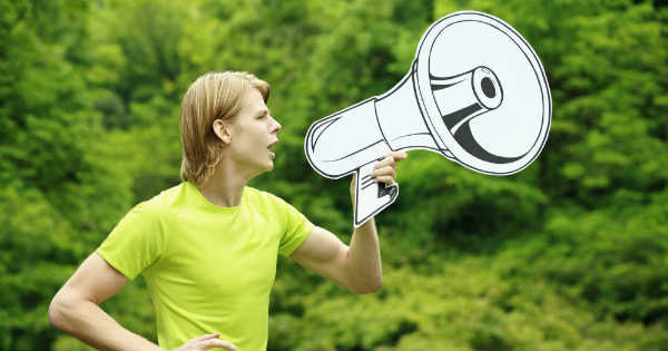 man talking out of a cartoon loudspeaker