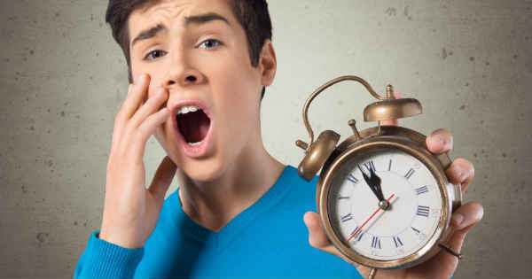 man waking up with alarm clock