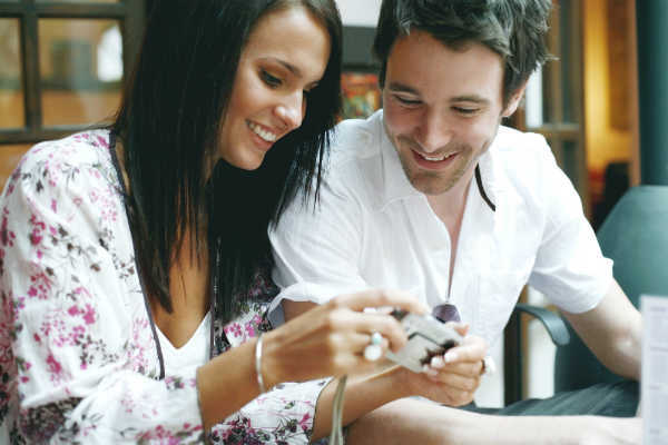 man and a woman looking through photos