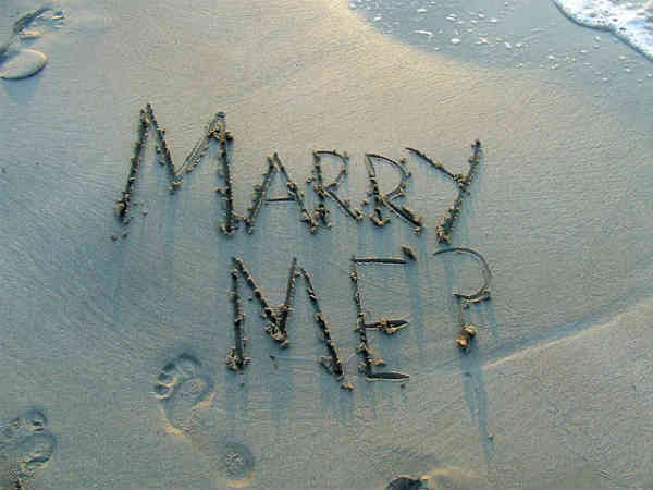 marry me writing in sand on the beach