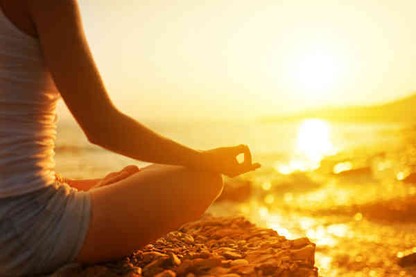 breathing and meditation on the beach during sunset