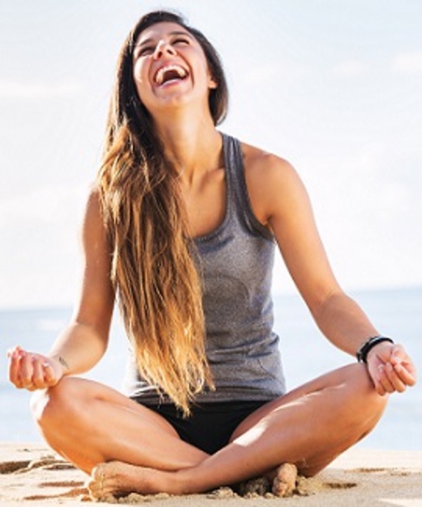 Girl enjoying meditating on the beach