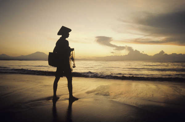 monk walking by the seashore