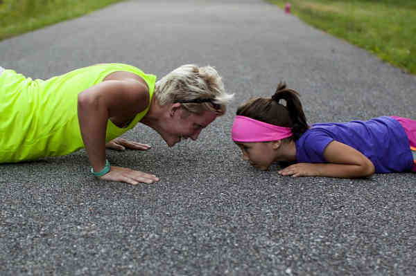 daughter and mother working out together