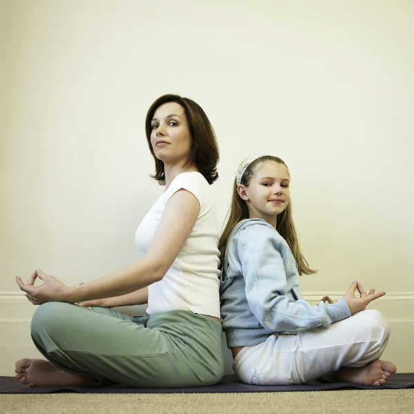 mom and daughter practicing breathing exercises together