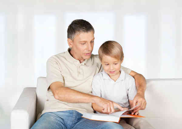 father and son reading a book