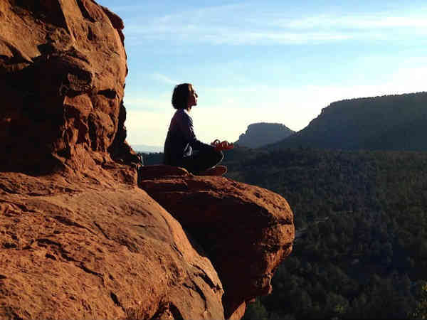 peaceful meditation on a rock cliff