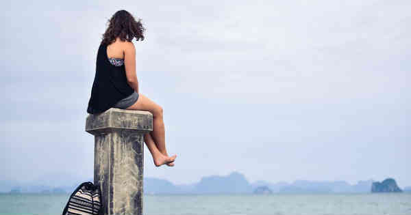 peaceful woman sitting on rock