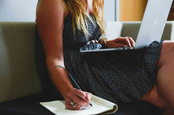 woman writing down her here and now list