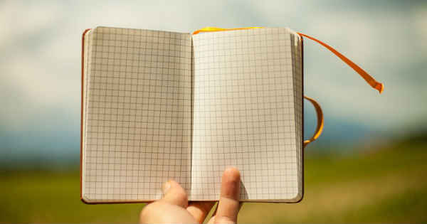 a person holding an empty diary in hand