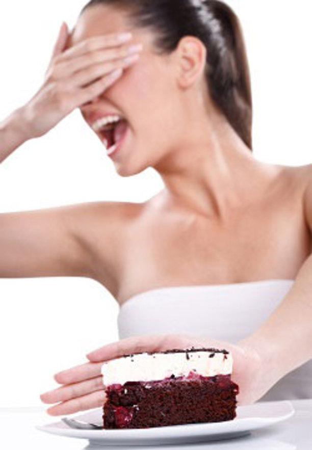 Girl pushing a cake away